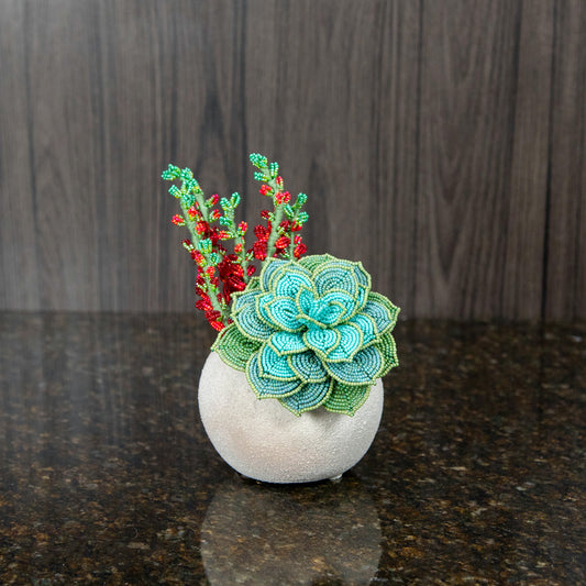 a handmade french beaded succulent in a round, stone pot